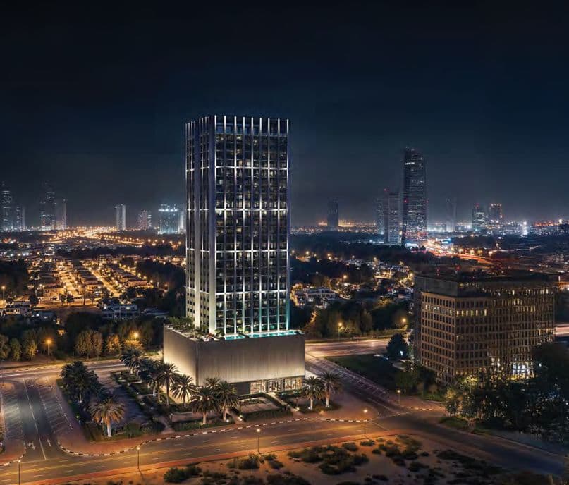 Jumeirah Village Circle — the tower at night above the community
